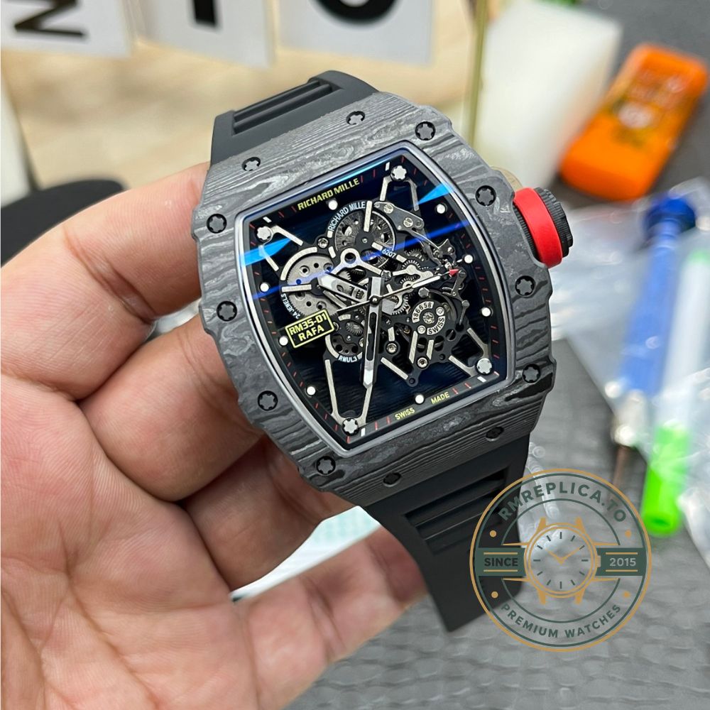 Richard Mille RM35-01 Rafa carbon fiber case black skeleton dial red crown black strap handheld angled detail view – replica richard mille watch