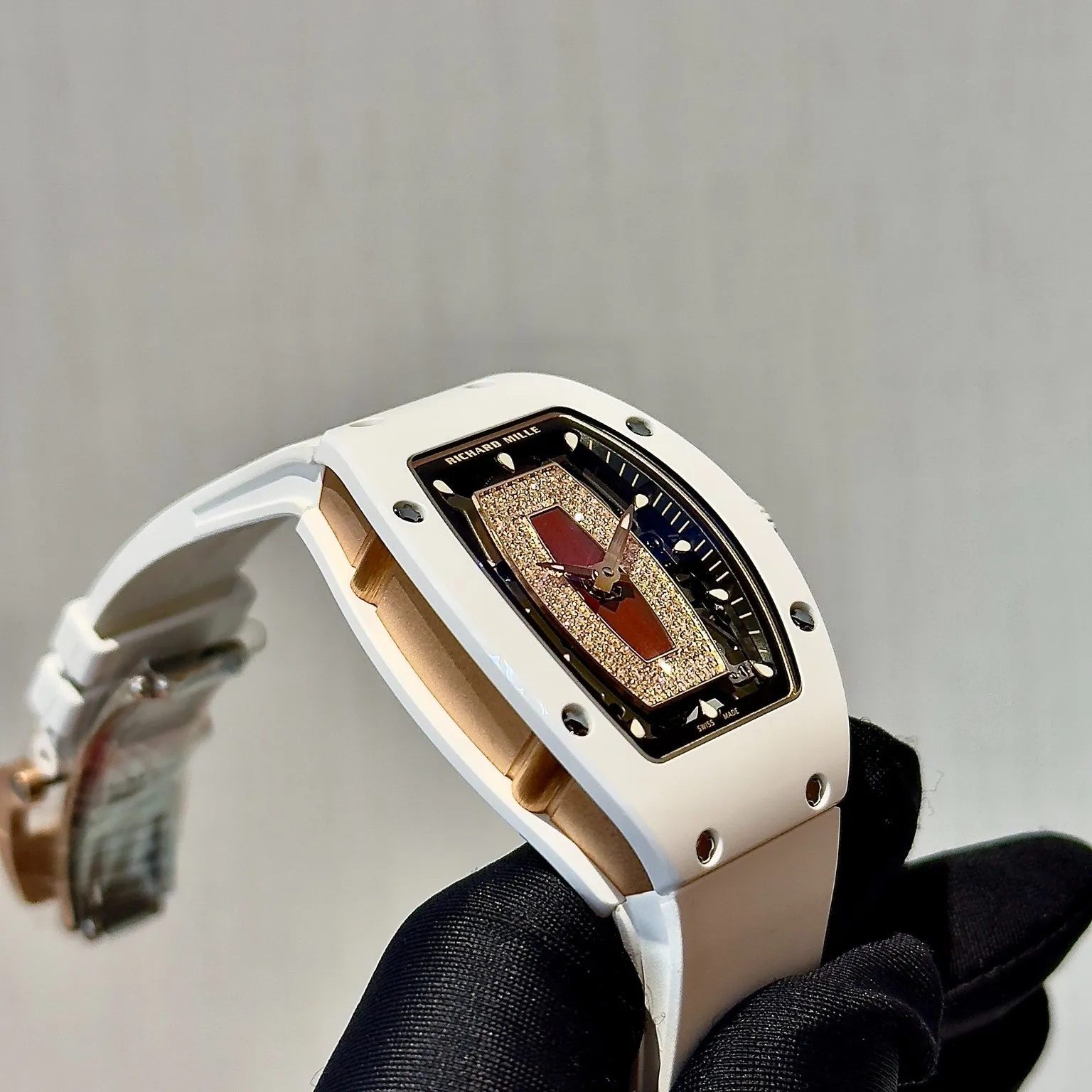 Detail of the soft white rubber strap and buckle on this richard mille fake watch for women.