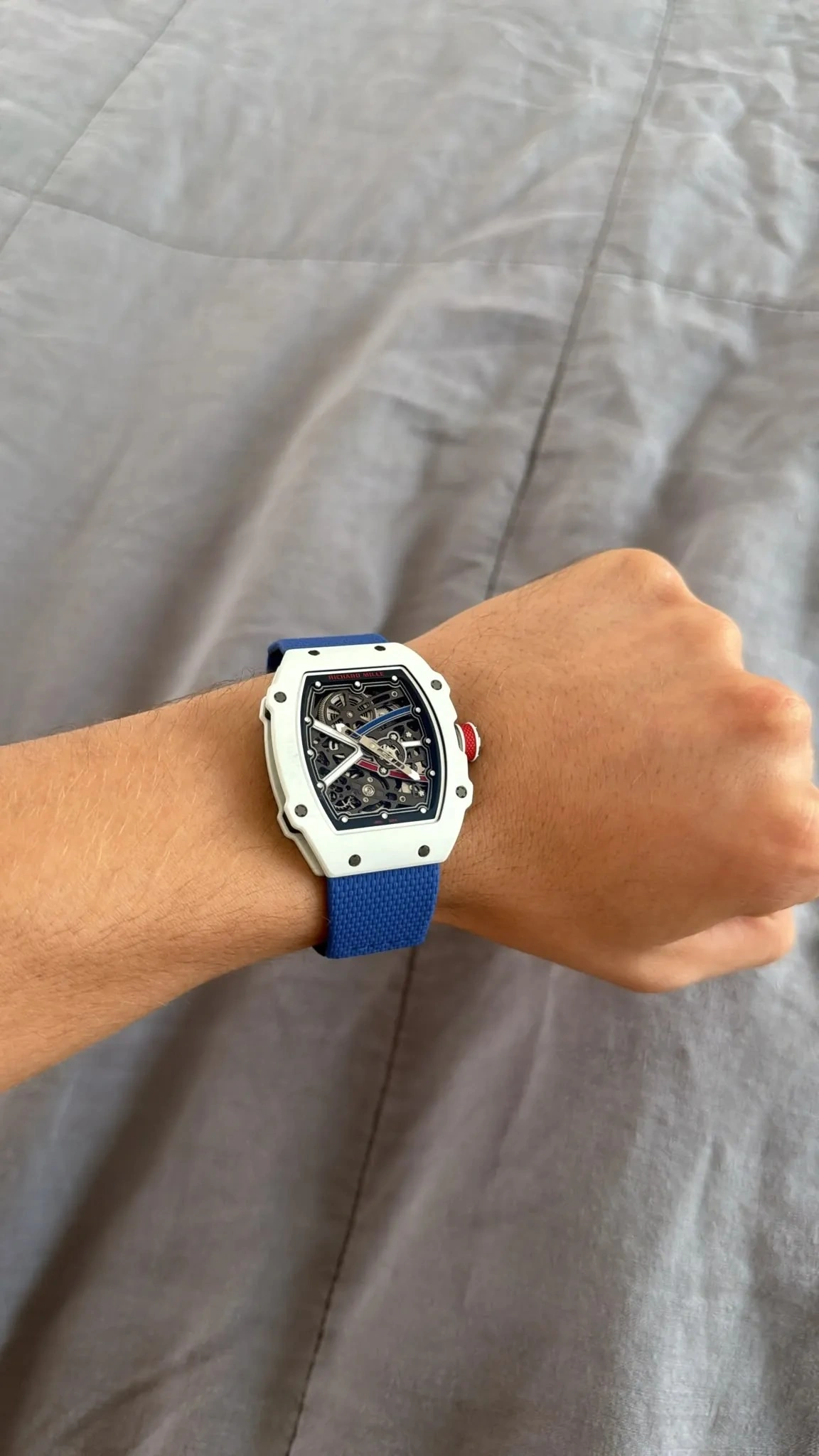 Customer wearing the Richard Mille RM 67-02 white watch with a blue strap during everyday use.